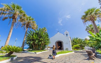 Photo of aerial view with Puerto de la Cruz, in background Teide volcano, Tenerife island, Spain.