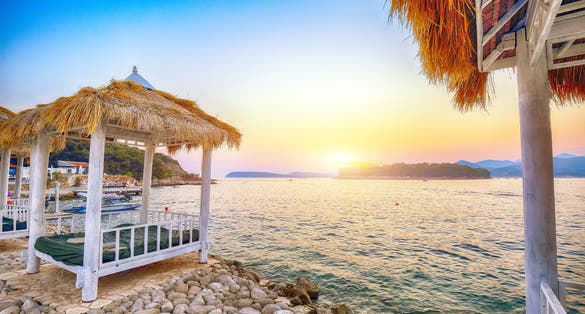 Photo of Thatched canopies and awnings on the beach Copacabana at sunset in Dubrovnik.