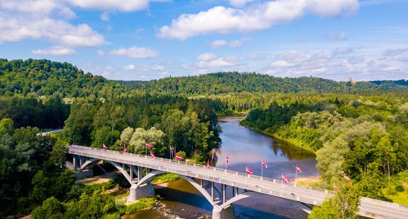 Aerial view of the Sigulda city with Gauja river and a bridge across it with cable car over the valley