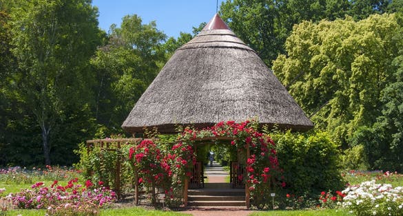 photo of view of Small hut in a rose garden in the Botanical Garden of Szeged Small hut in a rose garden in the Botanical Garden of Szeged, Hungary.