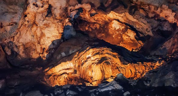 Photo of stalactites and stalagmites in Lipa Cave, formations Columns and Draperies, Montenegro.