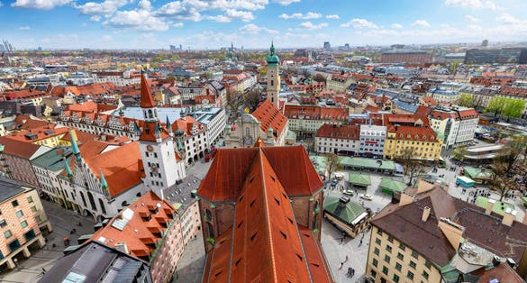 photo of view of Panoramic view of the skyline of Munich, Germany, with Viktualienmarkt and old townhall during a sunny day