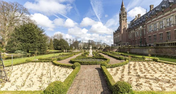 photo of beautiful garden of the Peace Palace or Vredespaleis in Dutch which is located in The Hague, Netherlands.