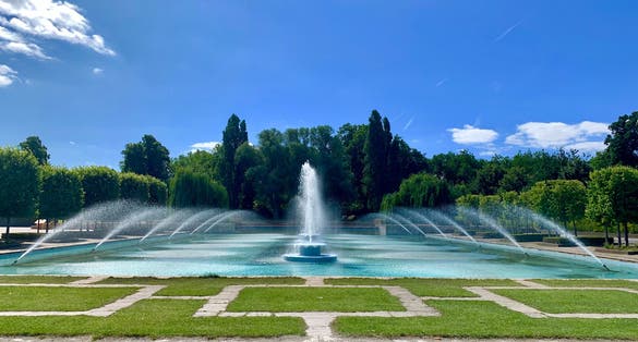 Photo of Beautiful outdoor water fountain with dancing waters on a sunny day in Battersea park, London .