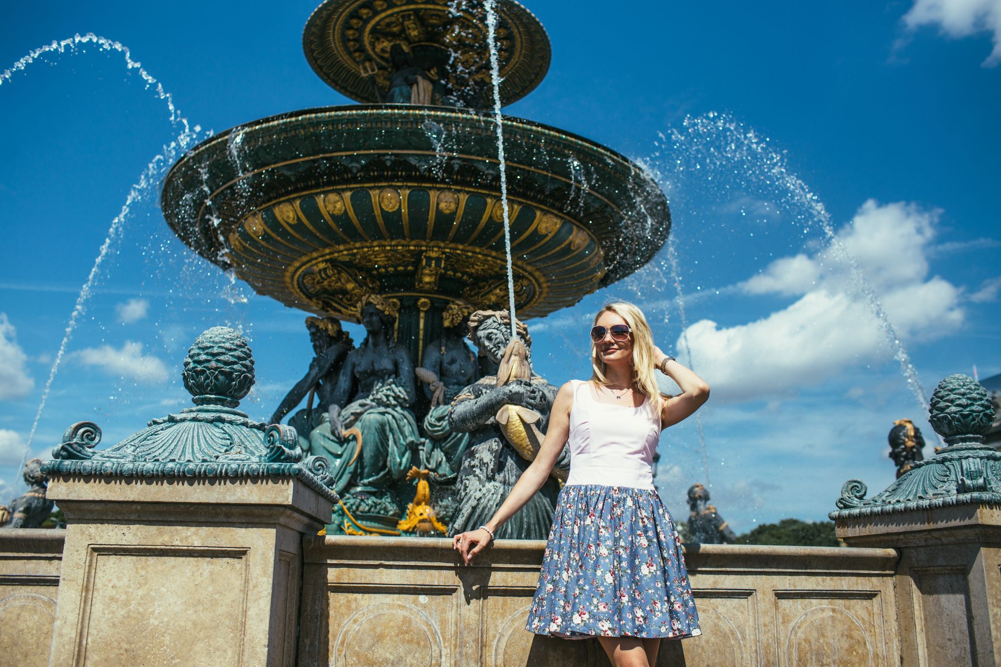  photo of beautiful girl with blonde hair in a beautiful dress on a background in Paris Hittorf Fountains at Place de la Concorde in France.