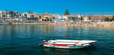 Photo of aerial view over People Crowd Having Fun On Beach And Over Cascais City In Portugal.