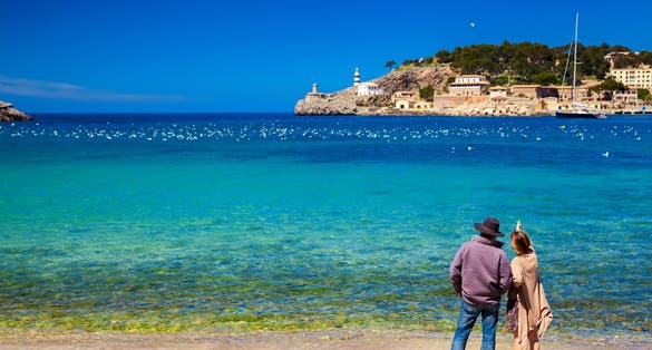 unrecognizable couple enjoying beautiful view of the harbour of Port de Soller, Majorca, Spain