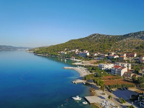 Photo of aerial view of coastal town of Seget Vranjica, Croatia.