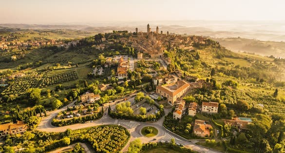 photo of view of Aerial view of famous medieval San Gimignano hill town with its skyline of medieval towers, including the stone Torre Grossa. Province of Siena, Tuscany, Italy.