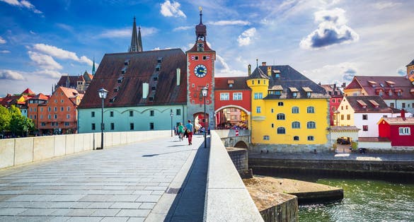 Regensburg, Germany, historical Stone Bridge, Bridge tower and buildings, Danube River.