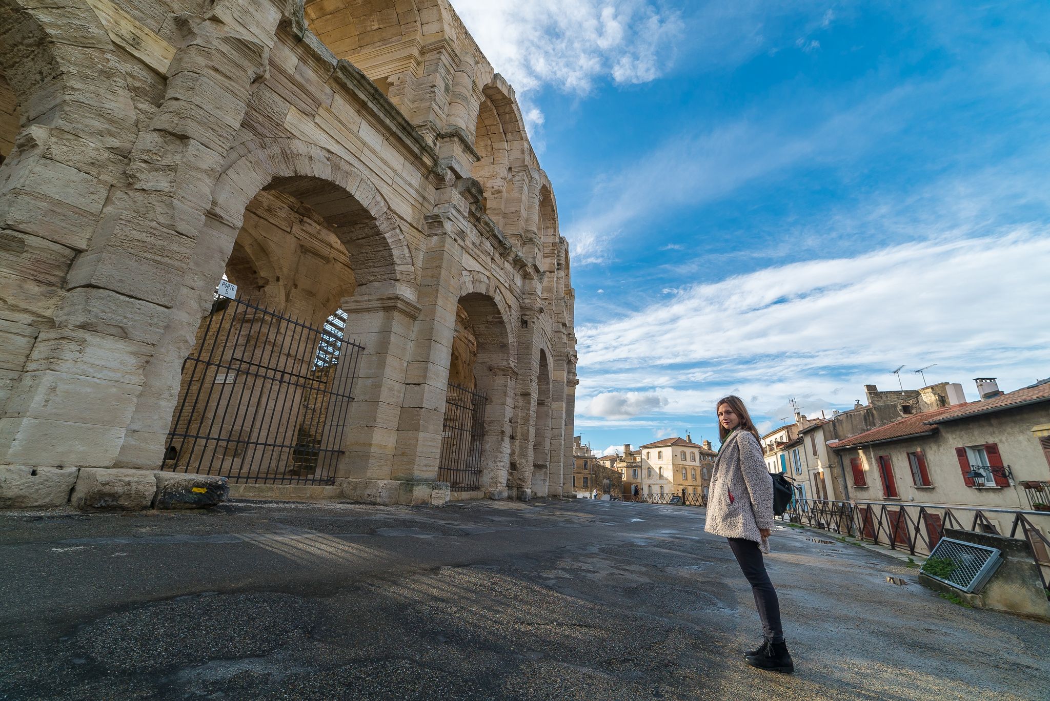 photo of happy tourist visiting Arles Amphitheatre in Arles, France.
