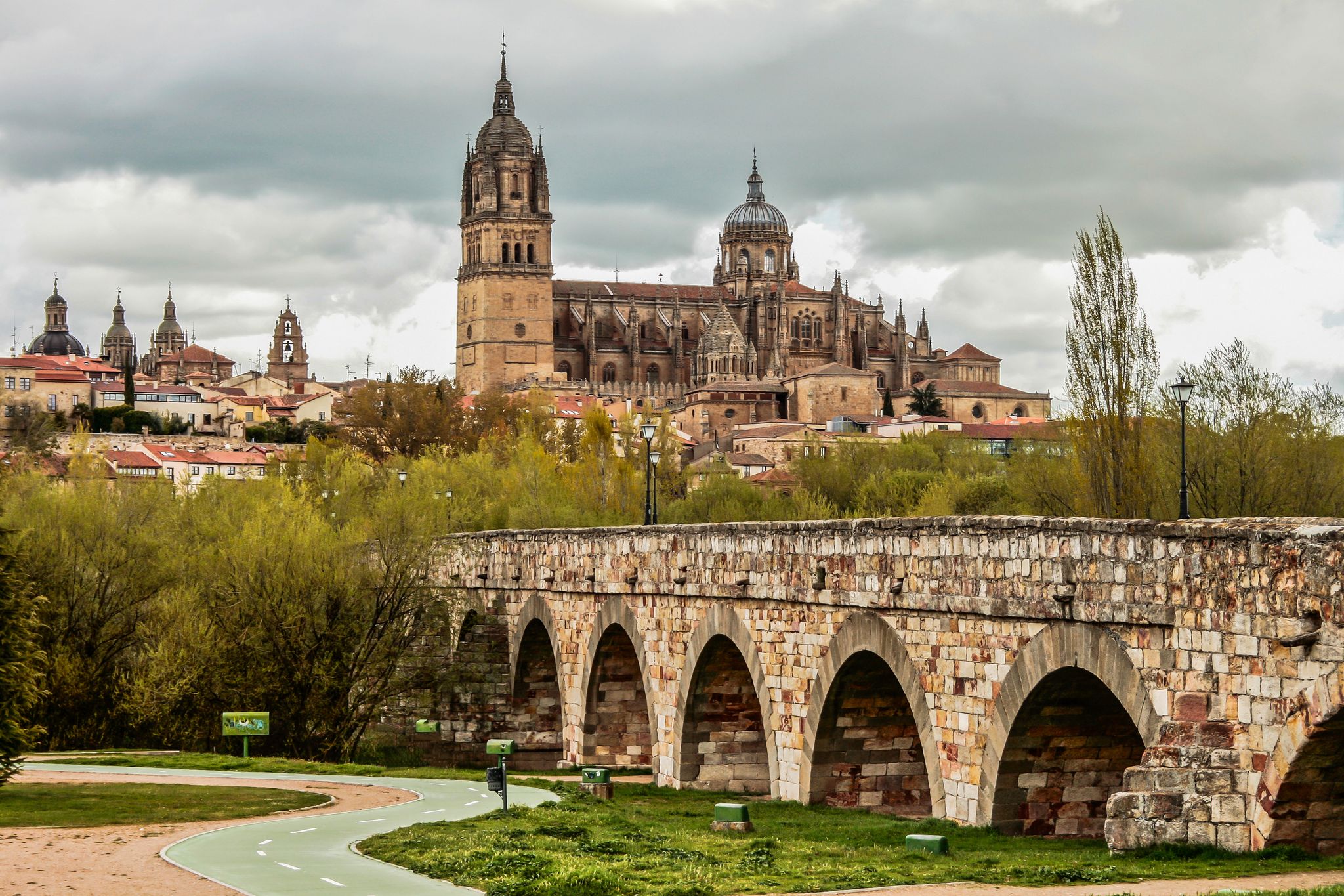 Photo of View on New Cathedral and roman bridge in Salamanca, Spain .