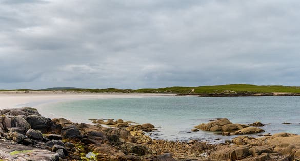 photo of view of panorama of Dog's Bay in County Galway in western Ireland with its beautiful white sand beach and shallow turquoise waters, Galway, Irland.