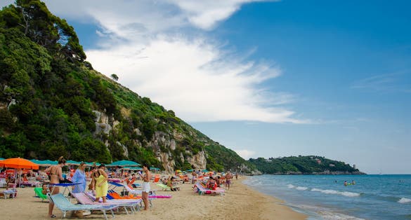 Beautiful beach with chaise longue and umbrellas in the gulf near Gaeta city. 