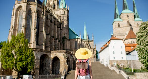 Morning view on the Mary Domberg cathedral with woman tourist in Erfurt city, Germany