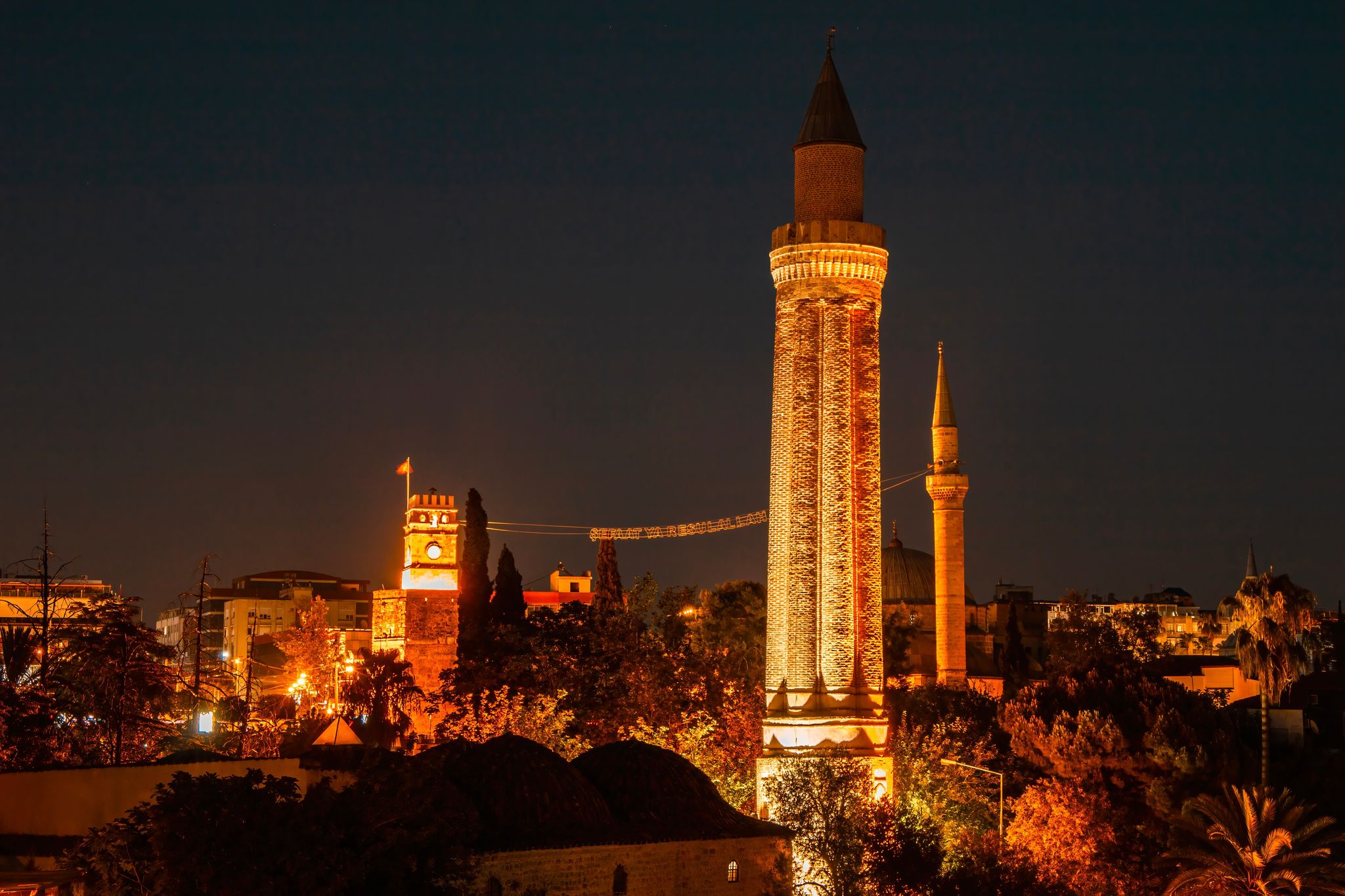 photo of night view of Yivliminare Mosque in Old town Kaleici in Antalya, Turkey.