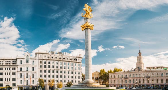 photo of Liberty Monument Depicting St George Slaying the Dragon and Tbilisi City Hall in Freedom Square in City Center in Georgia. Famous Landmark.