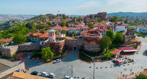 photo of Ankara Castle main gate with tower and historic residential buildings aerial view. The castle is an historic fortification in Altindag district in city of Ankara, Turkey.
