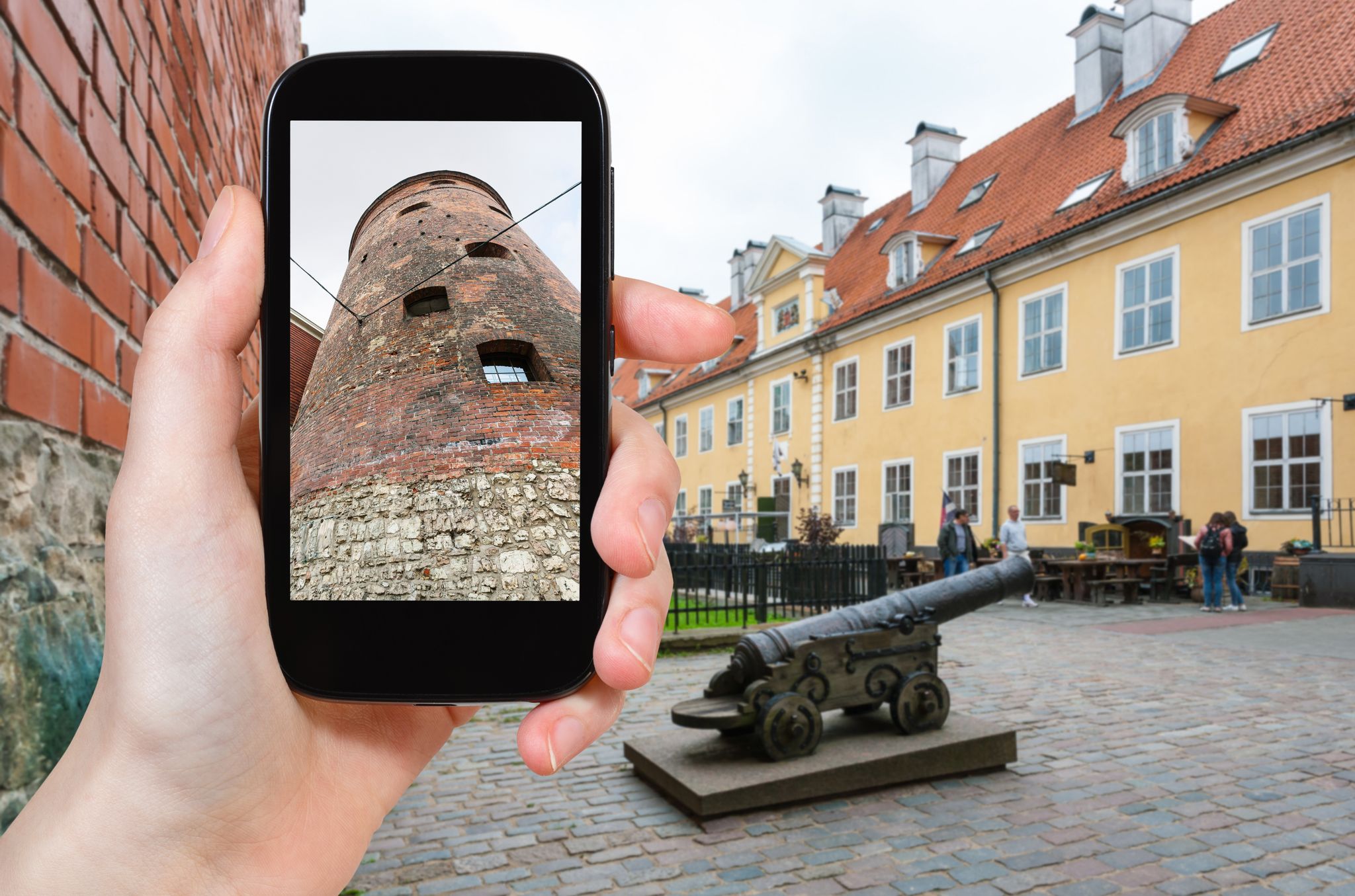 travel concept - tourist photographs Powder Tower, the part of old town walls, in Riga city in Latvia in september on smartphone