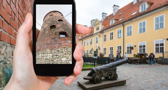 travel concept - tourist photographs Powder Tower, the part of old town walls, in Riga city in Latvia in september on smartphone