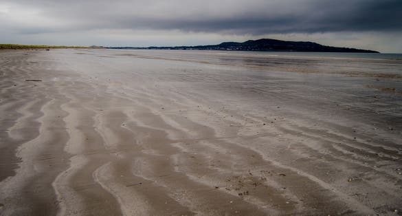 photo of Bull Island - Ireland, Beach and Beachrocks on a Rainy Day .