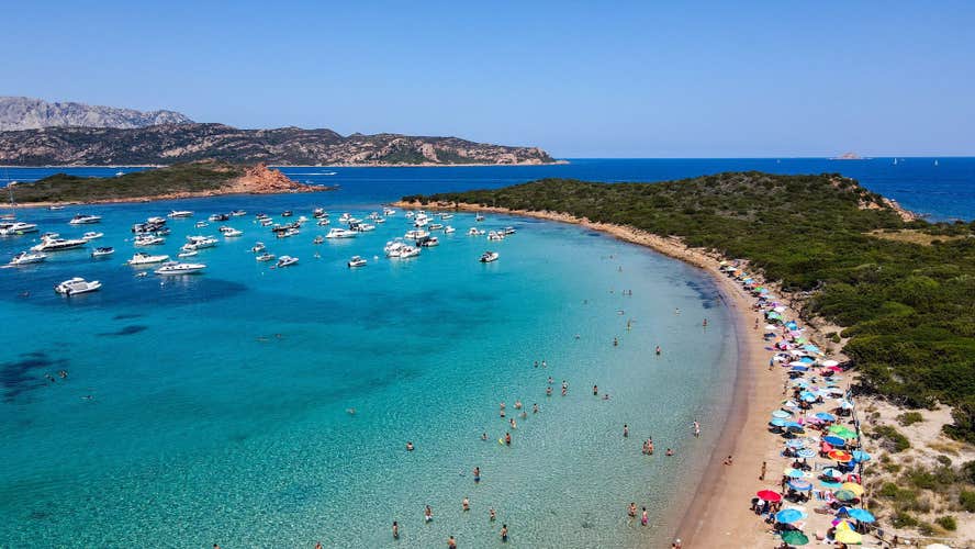 Aerial view of Capo Coda Cavallo Beach (Tail of the horse), San Teodoro, Sardinia Island, Italy. Drone view of yachts in a clear sea water, mediterranean. Tavolara and Molara Island, Sardegna.