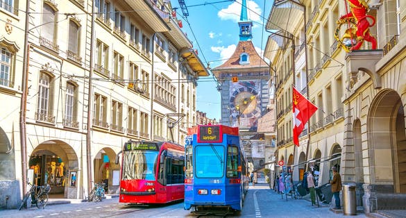 Photo of streets with shopping area and Zytglogge astronomical clock tower in the historic old medieval city centre of Bern, Switzerland.
