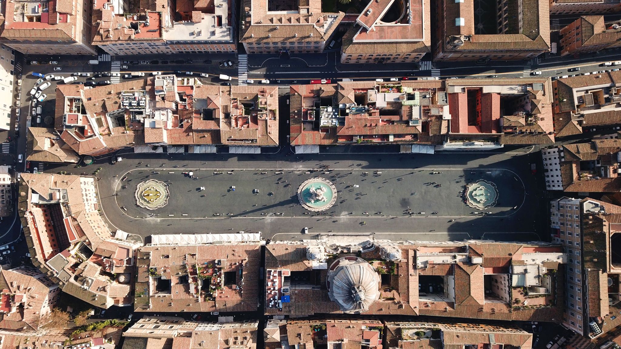 photo of aerial drone view of iconic landmark piazza navona square featuring fountain of the four rivers with an egyptian obelisk and sant agnese church in the heart of Rome, Italy.