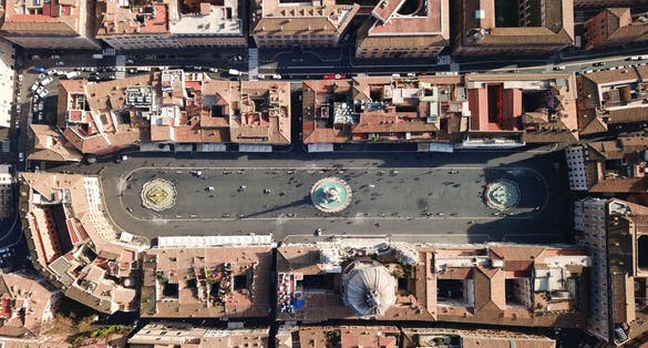 photo of aerial drone view of iconic landmark piazza navona square featuring fountain of the four rivers with an egyptian obelisk and sant agnese church in the heart of Rome, Italy.