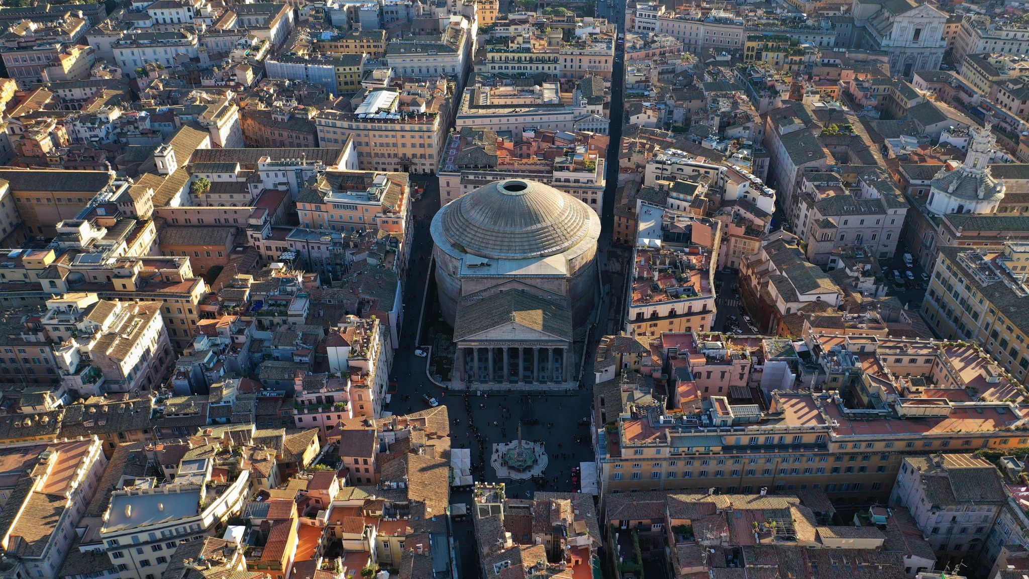 photo of aerial drone photo of iconic temple of pantheon built in 118 to 125 A.D. with a dome and renaissance tombs, including raphael's, Rome historic center, Italy.