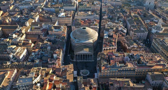 photo of aerial drone photo of iconic temple of pantheon built in 118 to 125 A.D. with a dome and renaissance tombs, including raphael's, Rome historic center, Italy.