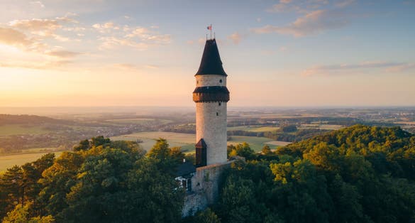 Photo of aerial view of watchtower Stramberska Truba while sunset golden hour in Stramberk in the Czech Republic.