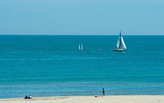 Photo of beach chairs, on a sandy, shoreline, in Giulianova, Italy.