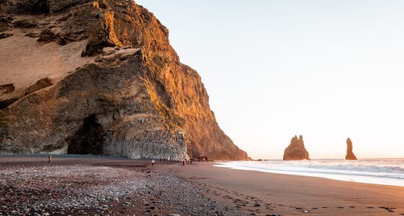 photo of  Hálsanefshellir Cave, a beautiful cave on a black sand beach during sunrise in Iceland.