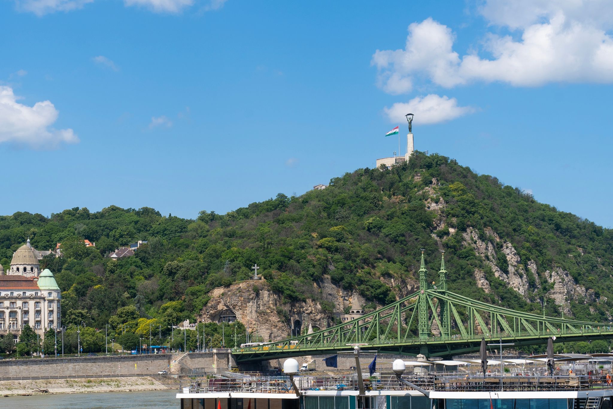 photo of viewLiberty bridge or Freedom bridge over the Danube river. Gellért Hill and the Statue of Liberty are in the background. Budapest, Hungary.