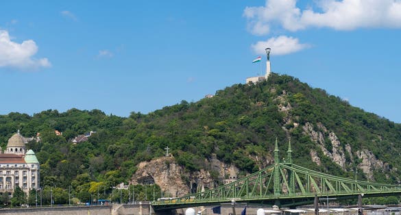 photo of viewLiberty bridge or Freedom bridge over the Danube river. Gellért Hill and the Statue of Liberty are in the background. Budapest, Hungary.