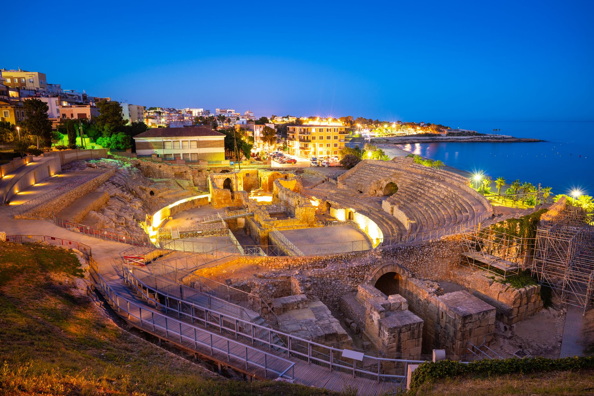 Photo of Amphitheater of Tarragona roman ruins at sunset in Catalonia Spain .