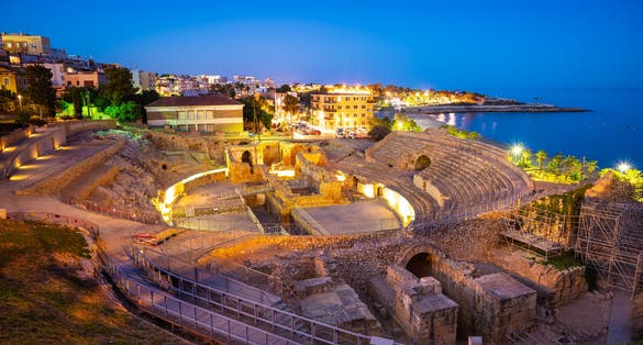 Photo of Amphitheater of Tarragona roman ruins at sunset in Catalonia Spain .