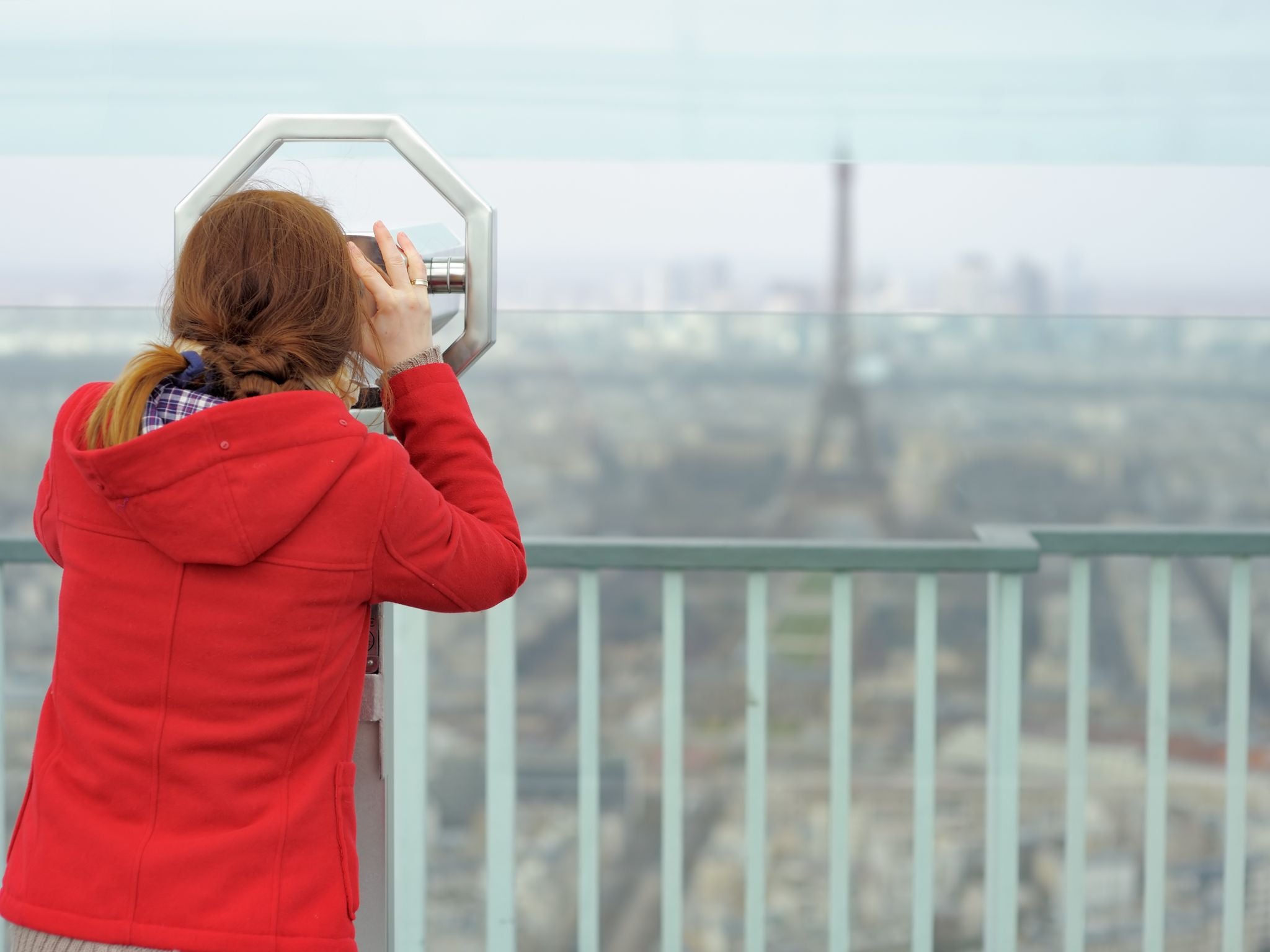 photo of young beautiful woman on observation deck in Montparnasse building in Paris, France.
