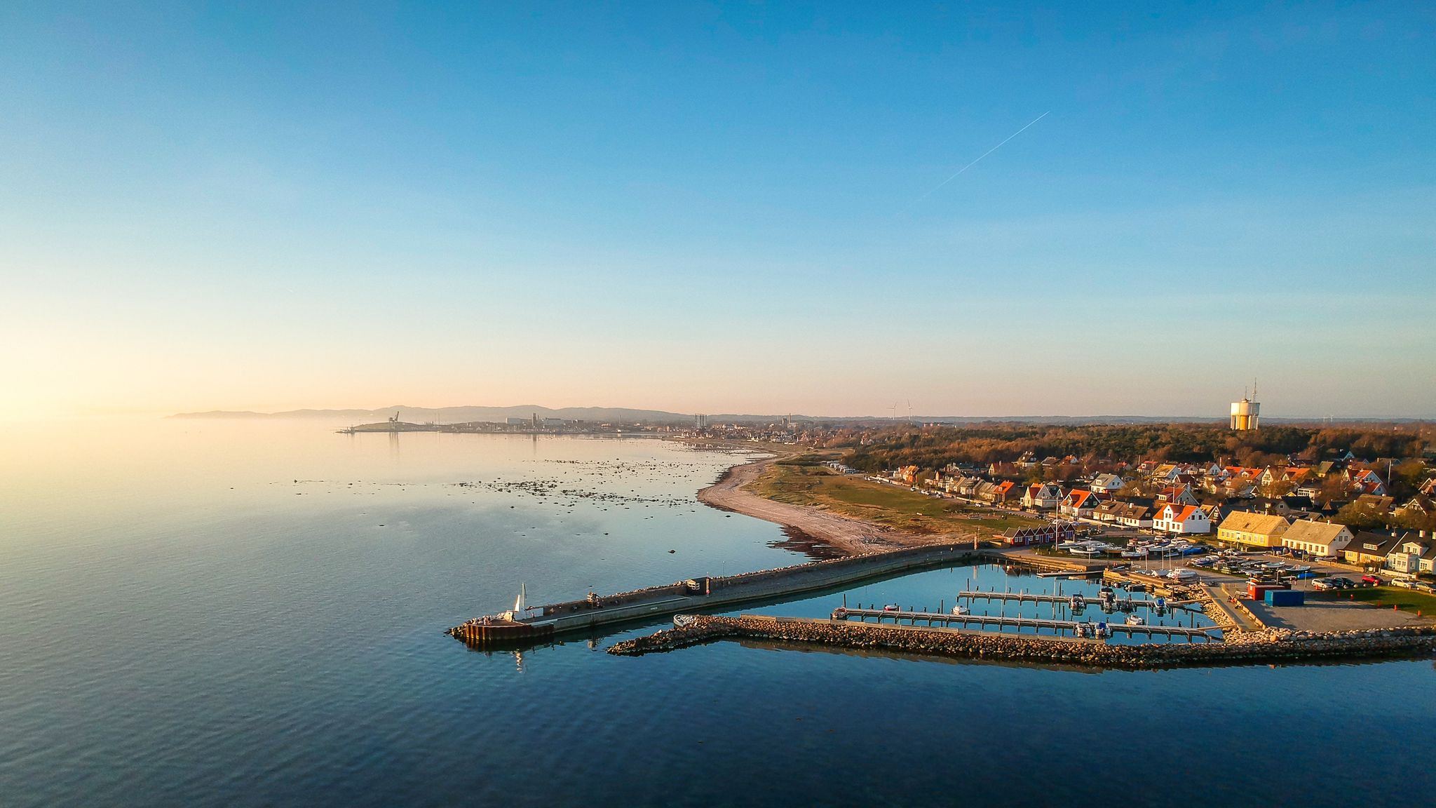 photo of view of Drone shots of Lerberget harbour in Lerberget, Skane, Sweden, with Kullaberg nature reserve, Hoganas city and Kullahalvon in the background.