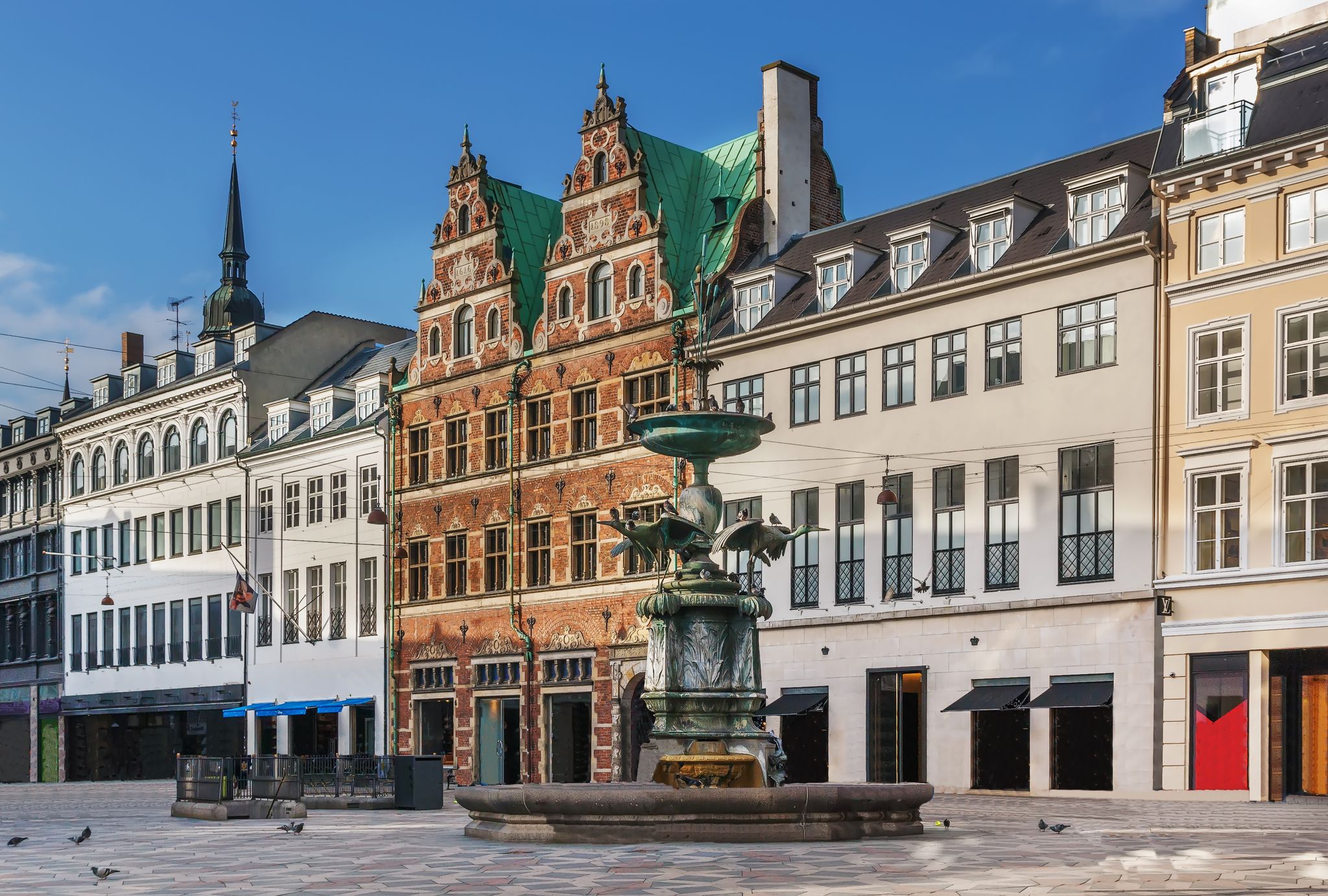Photo of Stork Fountain on the Amagertorv (Amager Square) and the longest pedestrian street in the world Stroget in Copenhagen, Denmark.