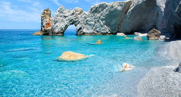 Photo of the famous rock with a hole in Lalaria Beach, Skiathos.
