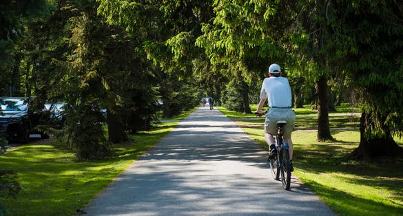Photo of cyclist riding in Pärnu Rannapark (Pärnu Beach Park). Popular walking and recreation area in Pärnu.