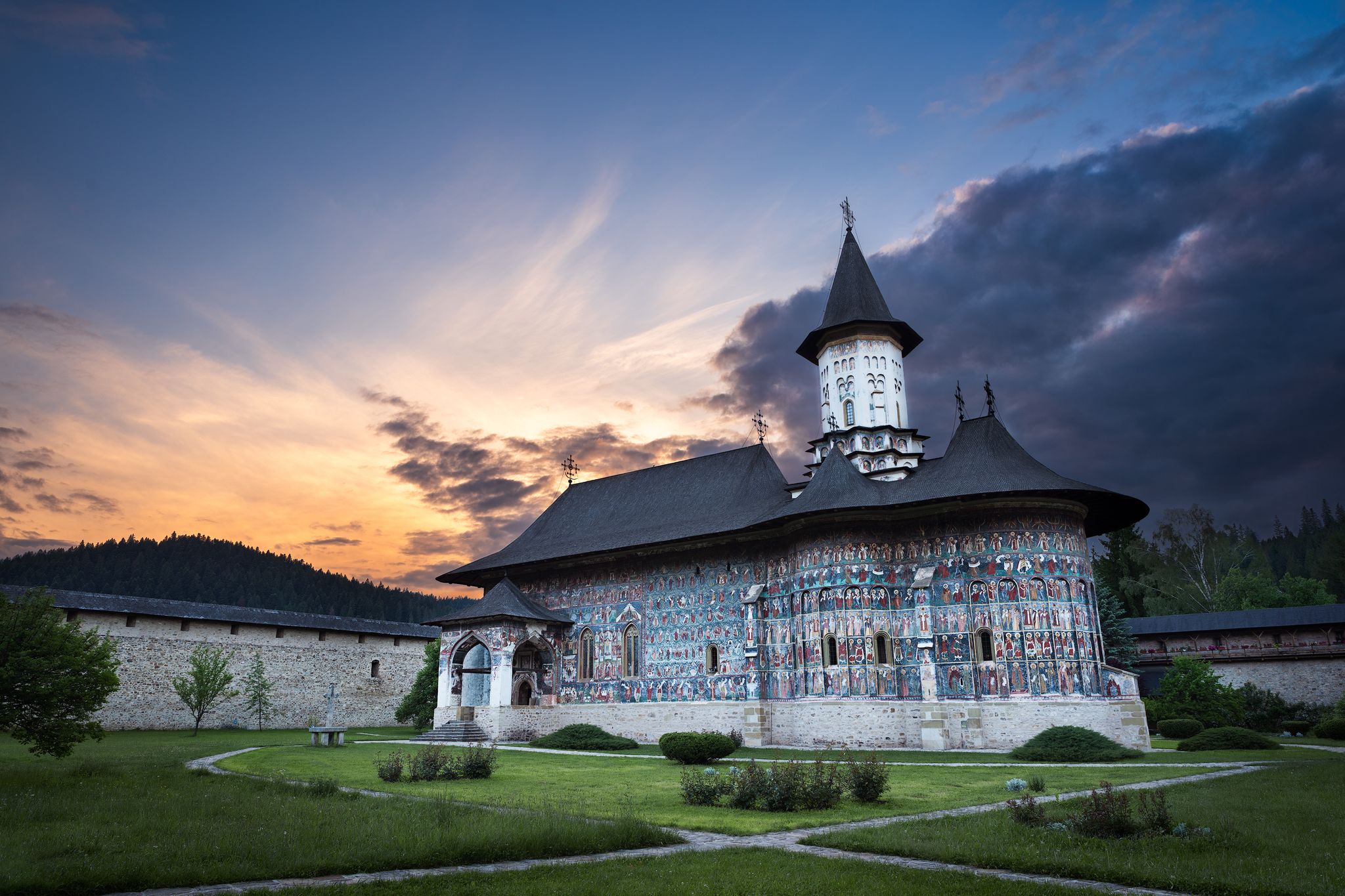 Photo of Sucevita Monastery in Romania at sunset.