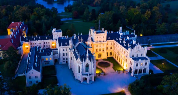 Photo of panoramic view of medieval castle Lednice by night Czech Republic.