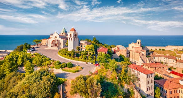 View from flying drone of Cattedrale di San Ciriaco church and San Gregorio Illuminatore - Catholic church. Spectacular summer cityscape of Ancona town, Italy, Europe. Traveling concept background..