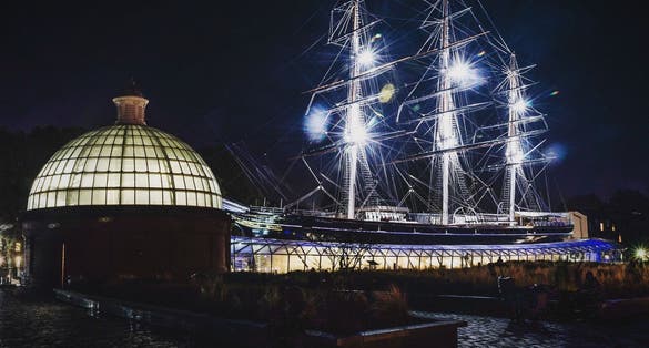 Photo of Cutty Sark illuminated at night, Greenwich, London, UK.