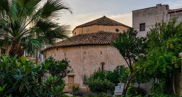 A view of the eleventh century Church of San Giovanni al Sepolcro in Brindisi in the Puglia region of Italy from the public access garden on its back side