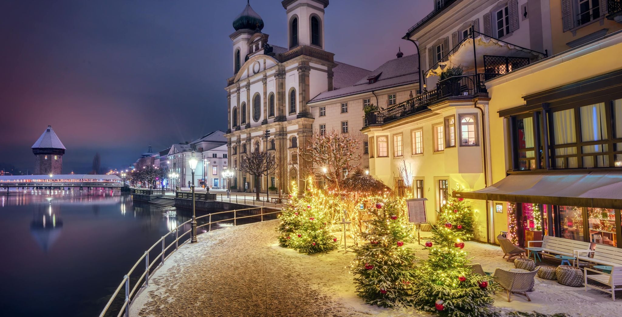 Lucerne waterfront decorated with Christmas trees and lights during a snowy December evening..jpg