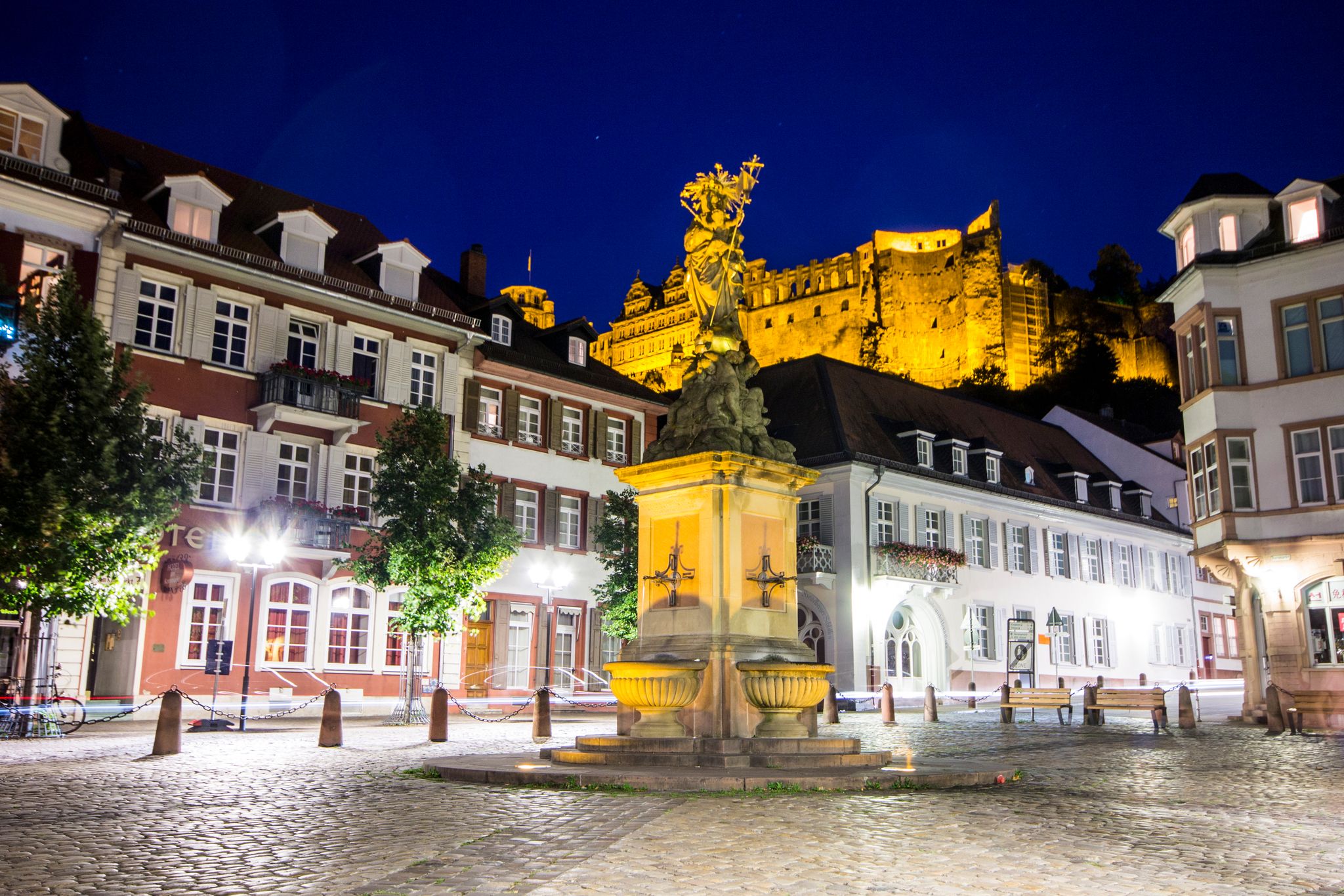 photo of view of Heidelberg, Germany. The Madonna statue in Kornmarkt square at nigh, Heidelberg, Germany.